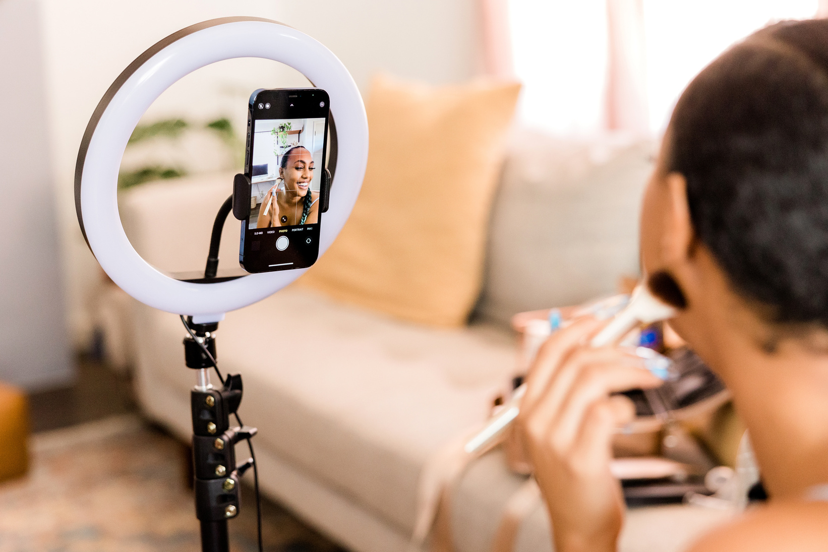 Woman Filming a Makeup Vlog at Home